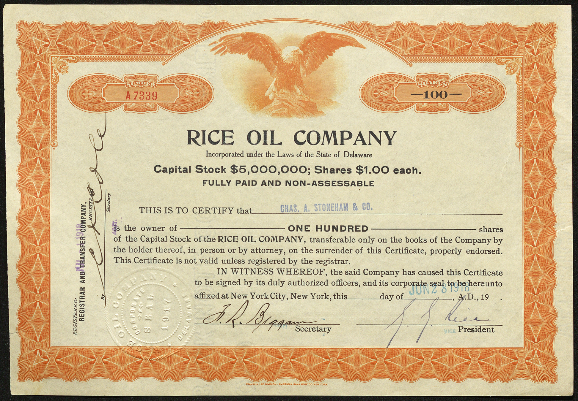 Certificate with black, blue, and orange ink shows intricate bordering, lettering, a company seal, signatures and a vignette of an eagle