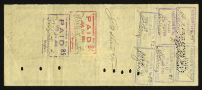 Backside shows legal language and space for dates, amounts, signatures and one red and one purple paid stamp