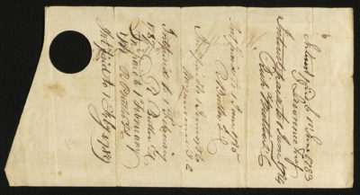 Back of certificate shows legal language, signatures, and a circle and bottom of certificate cut-outs