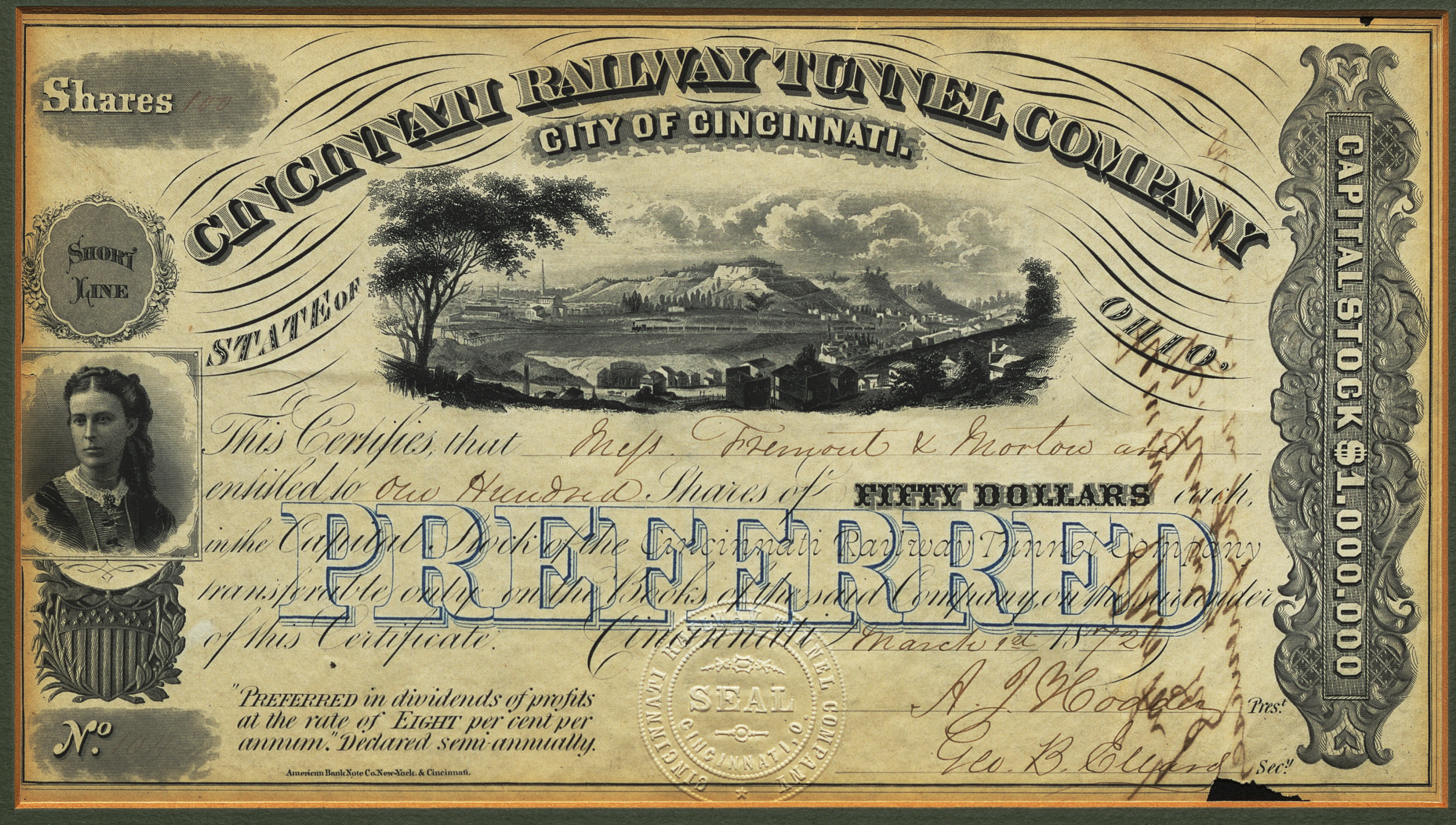 Certificate with black and blue ink shows intricate borders and lettering, company seal, and vignettes with a farm town and train and woman