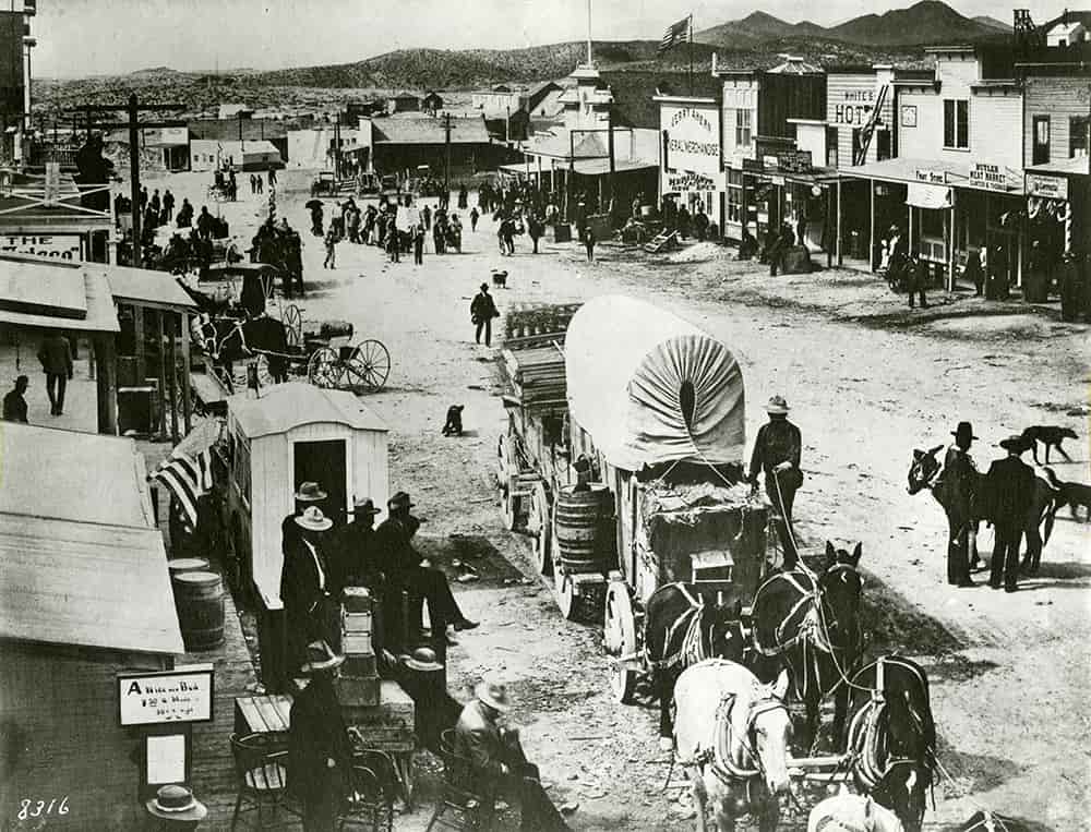 Black and white early street scene of Tonopah with a covered wagon in the foreground.
