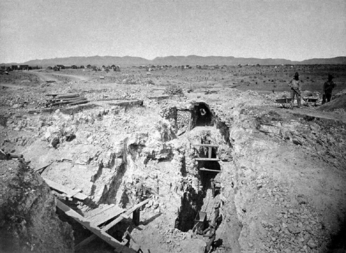 Black and white image of crevasse with mining timbers in it.